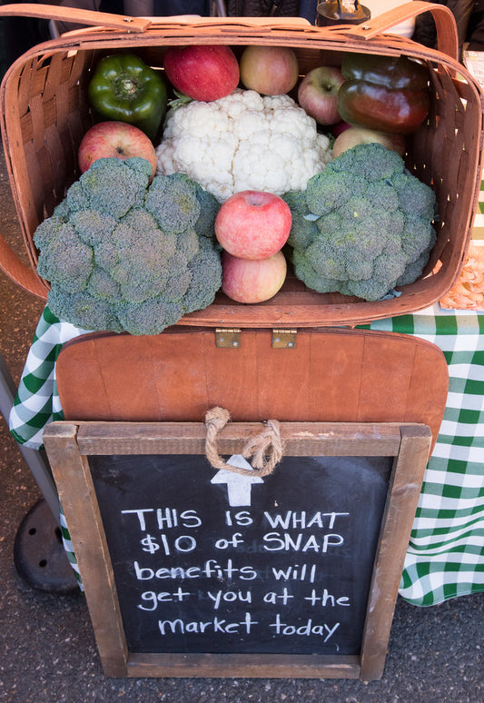 Garlic supplements for blood pressure displayed with fresh garlic and a blood pressure monitor on a table