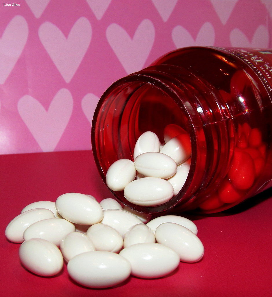 CoQ10 200 mg supplement bottle for heart health on wooden table