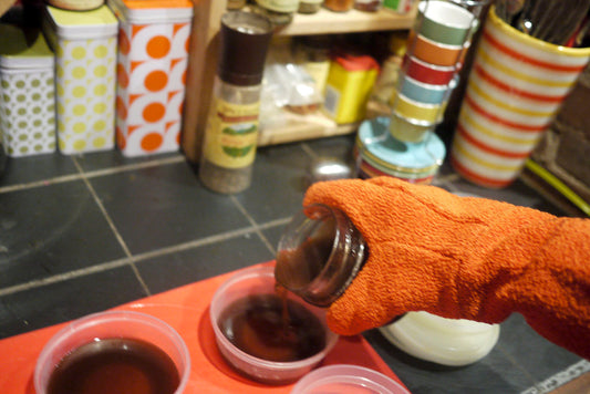 A woman holds a DIM supplement for estrogen balance as part of her morning routine, with a glass of water on a wooden table.