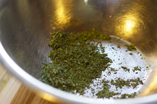 Slippery elm bark powder in a wooden bowl with a spoon, natural remedy for acid reflux relief