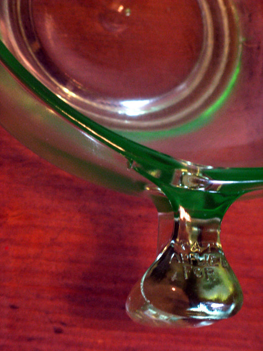 Chlorophyll drops benefits: a green liquid supplement bottle on a wooden table
