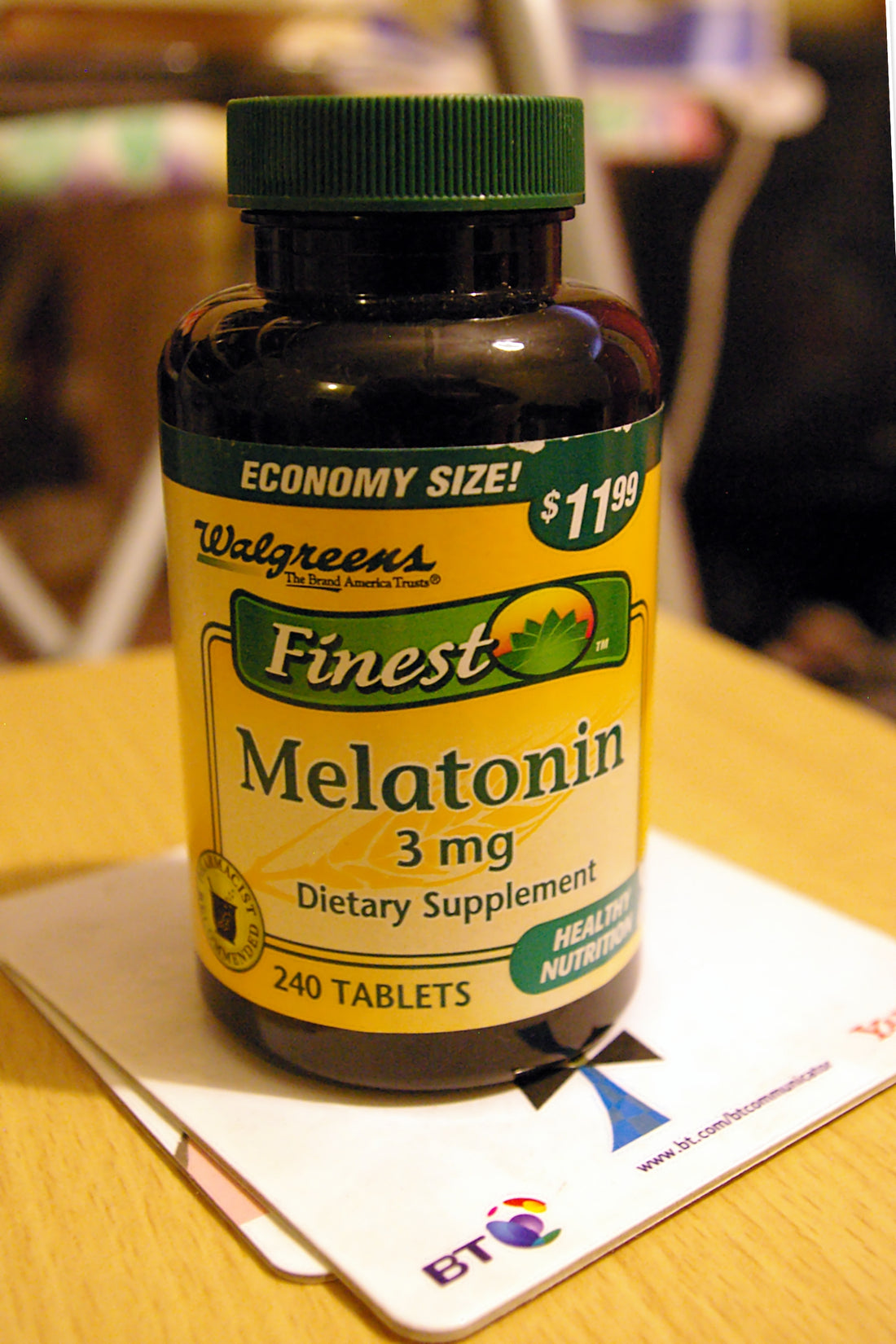Melatonin 10 mg fast dissolve tablets on a wooden table near a glass of water