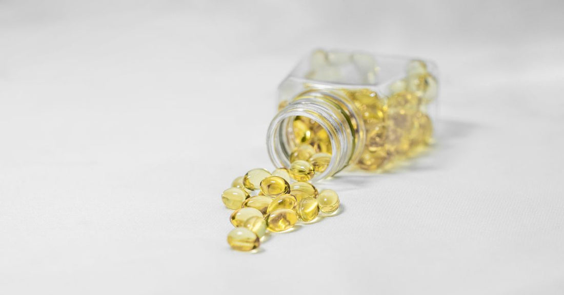 Bottle of evening primrose oil softgels for PMS relief on a clean surface