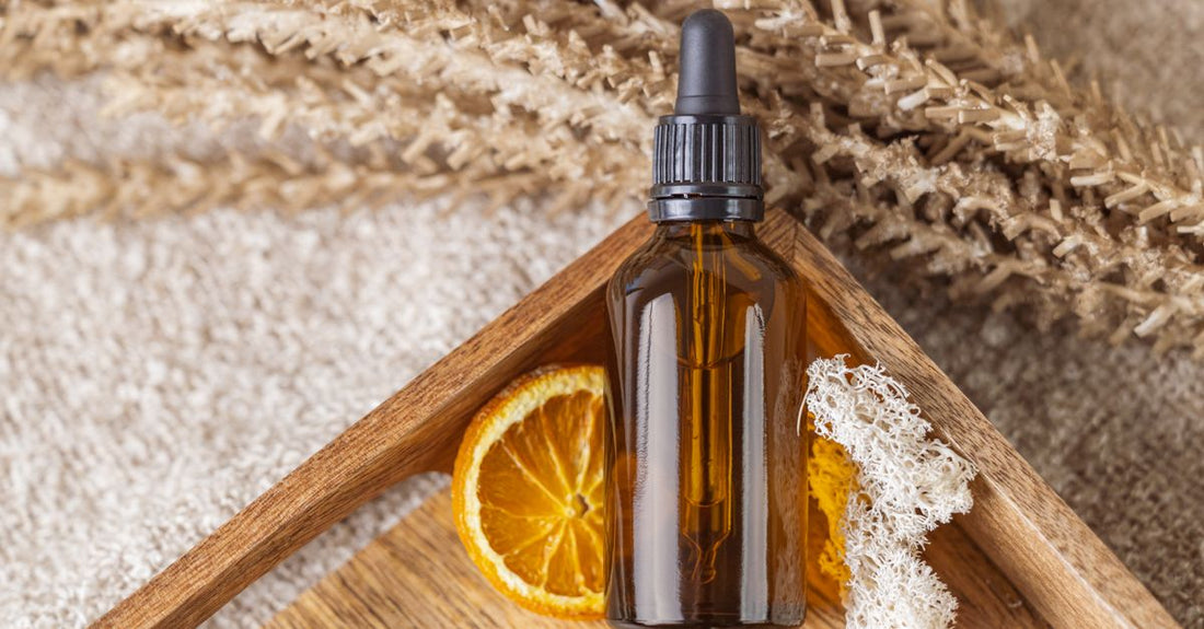 Vitamin C serum for face bottle on a marble surface with pipette