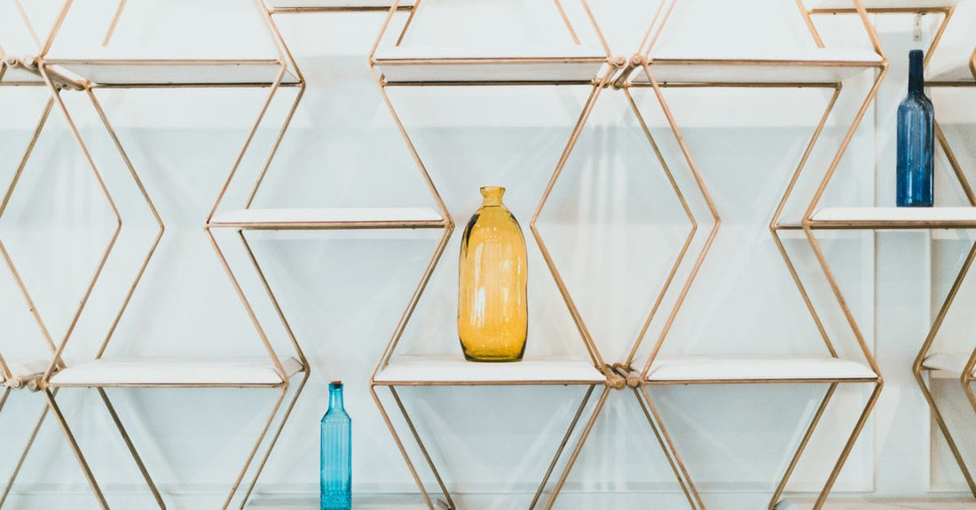 A colourful row of vitamin supplement bottles on a clean shelf, illustrating the vitamins buying guide UK.