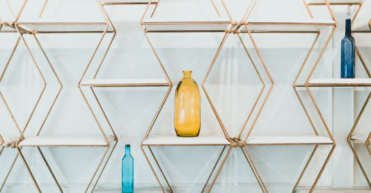A colourful row of vitamin supplement bottles on a clean shelf, illustrating the vitamins buying guide UK.