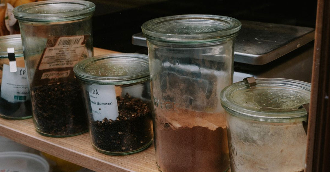 A glass jar of organic psyllium husk powder with a wooden spoon, representing a natural fibre supplement for a psyllium buying guide UK.