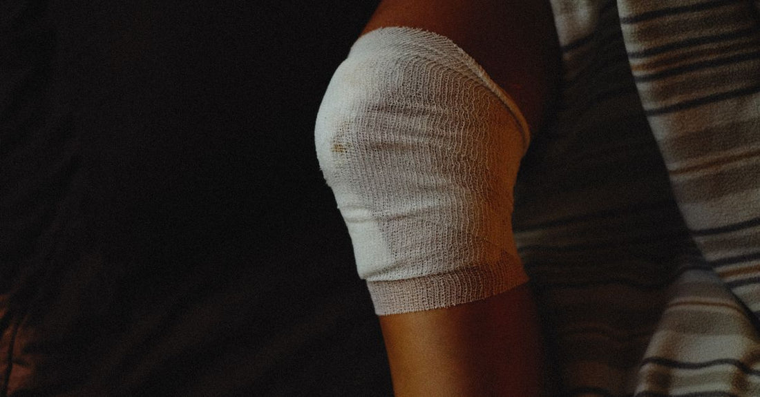 A variety of adhesive bandages in different shapes and materials laid out flat on a clean surface, illustrating how to choose adhesive bandages for every need.