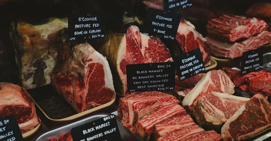 An array of fresh raw British beef cuts displayed on a butcher's block, illustrating how to choose beef UK