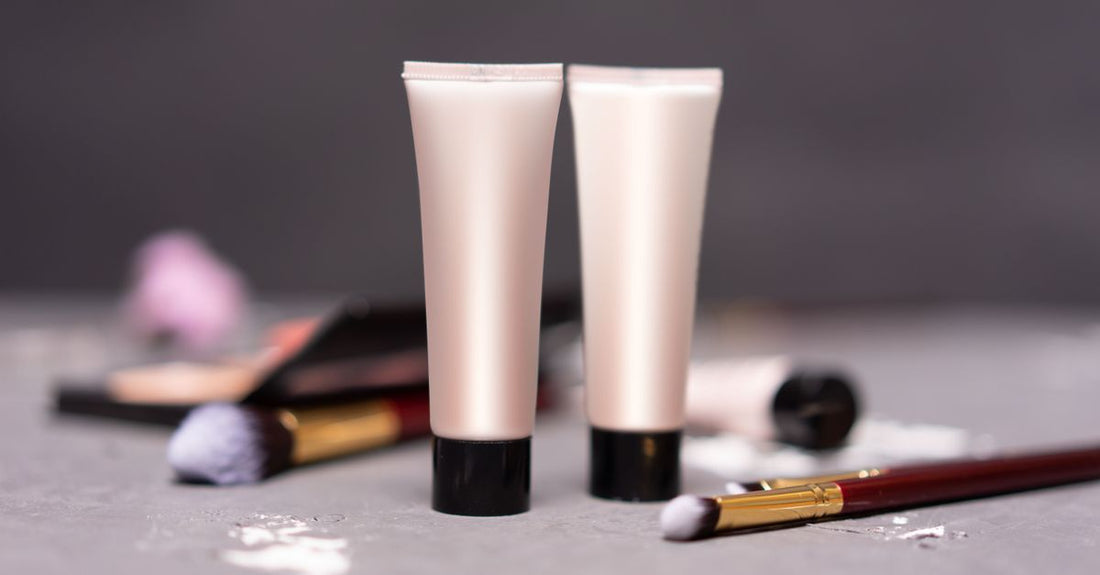A tube of antifungal ointment for skin placed on a clean white surface, with a subtle green botanical accent.