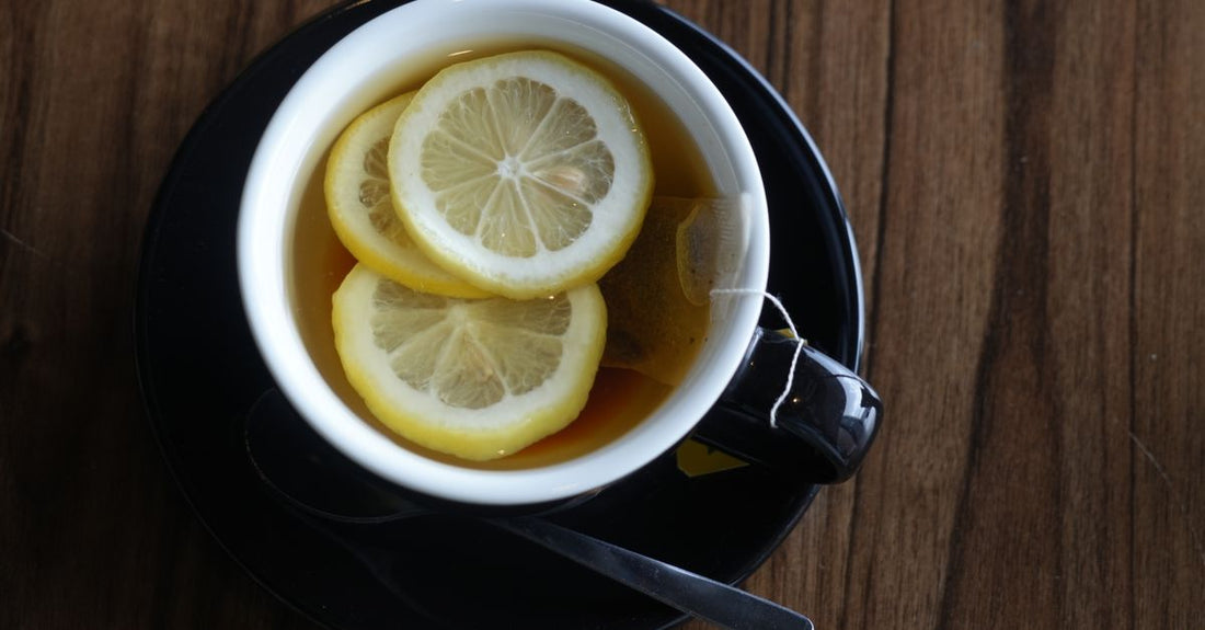 Detox tea for weight loss routine with a cup of herbal slimming tea on a light background, surrounded by tea bags and fresh herbs.
