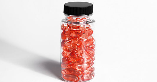 Cranberry supplements for UTI capsules in a glass jar on a white surface