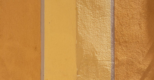 Assorted adhesive bandages in fabric and clear materials laid flat on a white surface, illustrating how to choose adhesive bandages for different wound types.