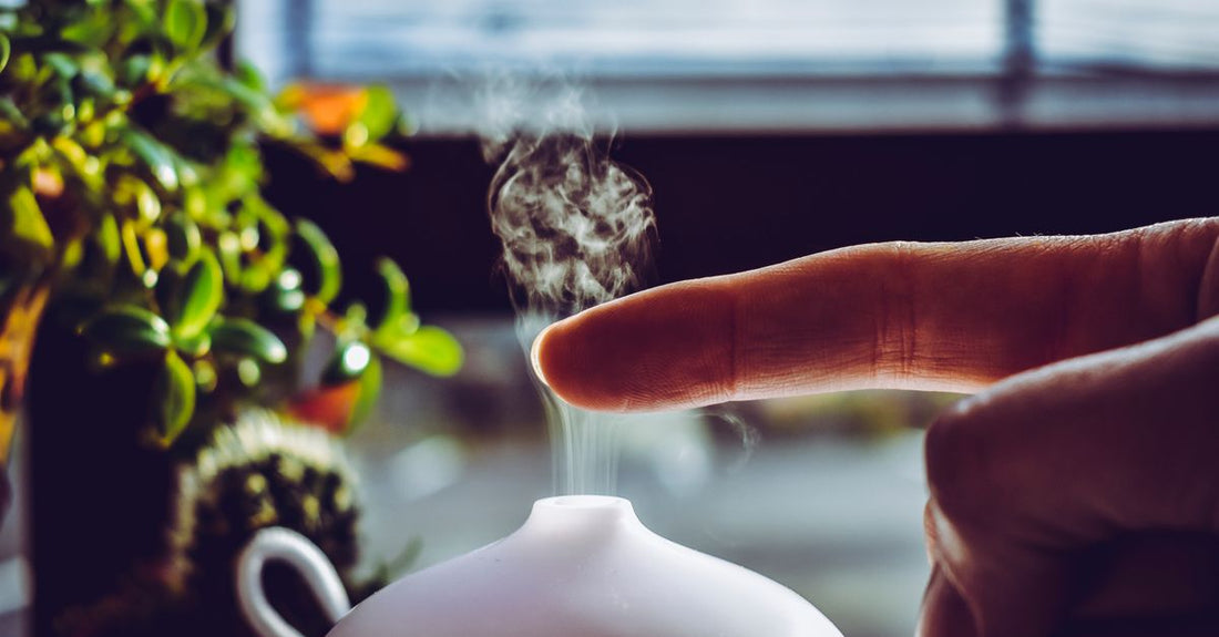 Essential oil diffuser for bedroom emitting soft mist on a nightstand