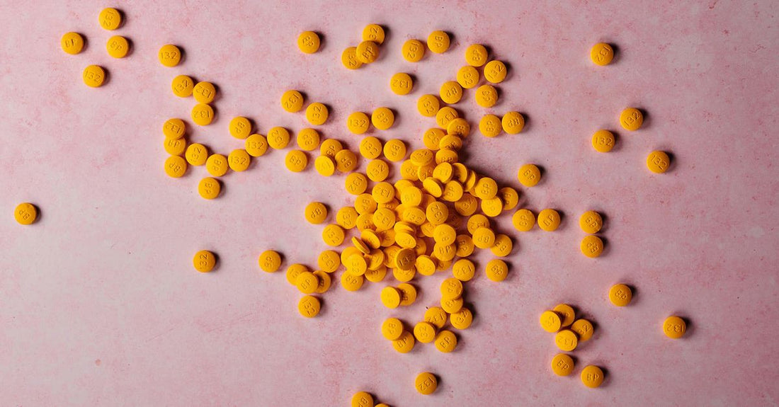 A bottle of folic acid supplements on a clean white surface, relevant to a B9 (folic acid) buying guide UK.
