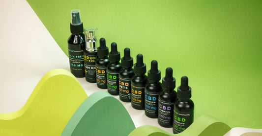 A glass bottle of chlorophyll liquid drops next to fresh mint leaves on a marble surface, illustrating how to choose chlorophyll UK.
