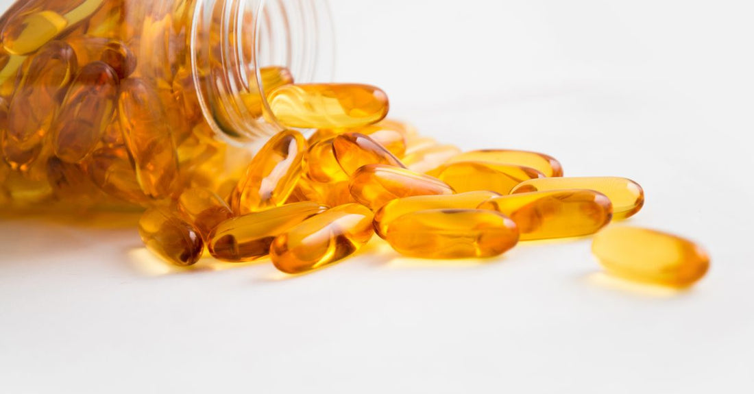 Bottle of omega 3 6 9 supplement capsules on a white background