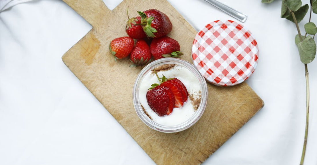 A white jar of acidophilus probiotic capsules on a clean surface, representing a buying guide for budget-friendly gut health supplements in the UK.