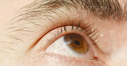 Selection of eye health supplement capsules and softgels on a bright surface, representing how to choose eye health UK products.