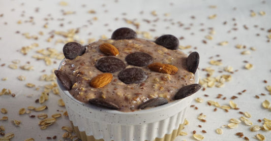 A wooden bowl filled with golden and brown flaxseeds on a rustic table, illustrating the flaxseed buying guide UK.