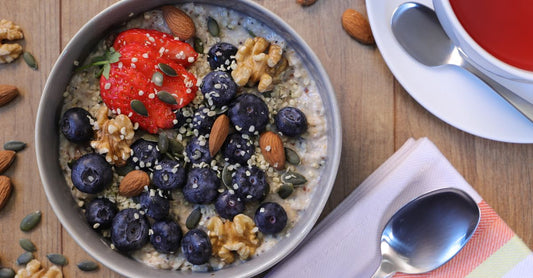 A bowl of raw shelled hemp seeds on a neutral surface, illustrating a plant-based omega-3 source.