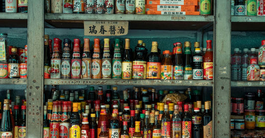 A colourful array of vitamin and mineral supplement bottles on a shelf, illustrating how to choose vitamins UK shoppers need.