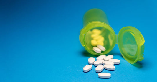 Bottle of melatonin tablets for jet lag relief on a bedside table.