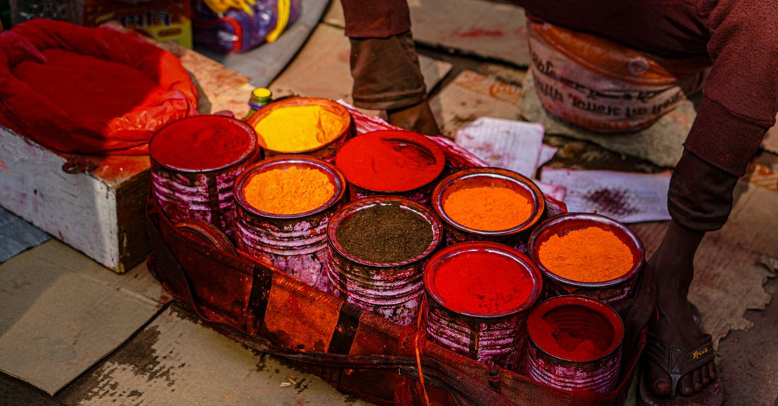 Turmeric supplement capsules and a wooden scoop on a clean surface in the UK, illustrating a turmeric buying guide.