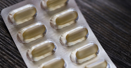 Bottle of ashwagandha capsules on a wooden shelf, representing thyroid support supplements