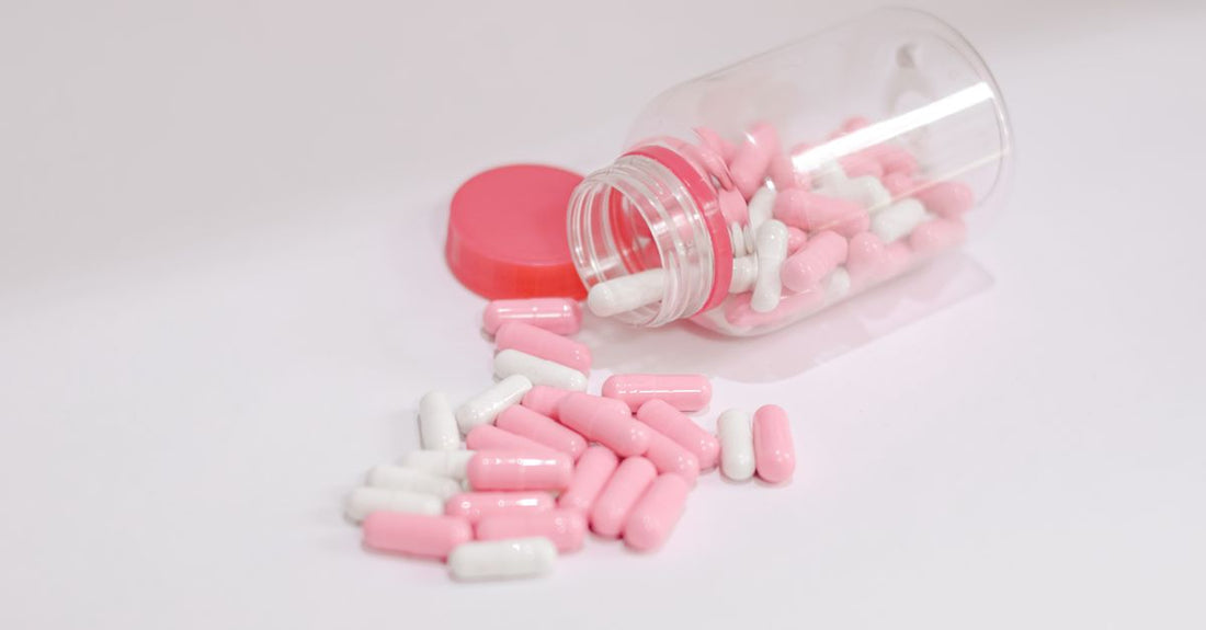 Niacin for cholesterol supplement bottle on a white background with tablets scattered.
