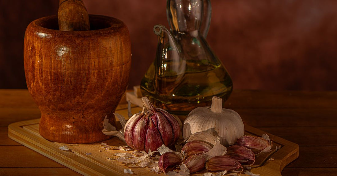 A flat lay of garlic supplement capsules and fresh garlic cloves on a white background, illustrating the best garlic UK 2026 supplements available at Nutrisentra.