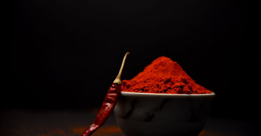 A bowl of organic ashwagandha powder with a wooden scoop, representing how to choose ashwagandha supplements in the UK.