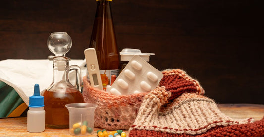 Alternative medicine buying guide: flatlay of herbal supplements, tinctures, and natural remedy bottles on a light wood surface.