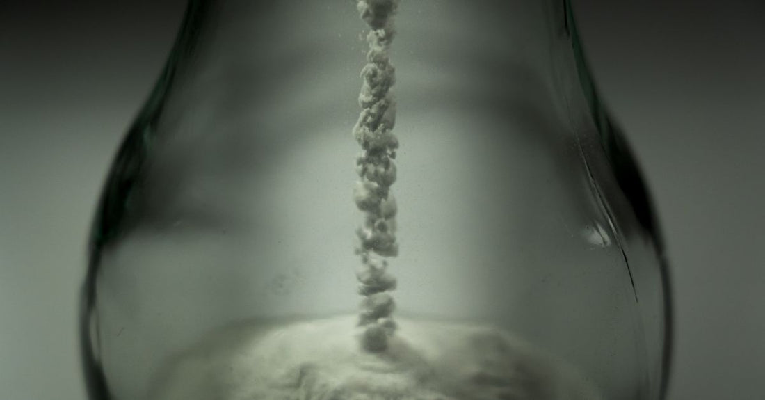 Amino acid powder jar on a clean clinical surface, illustrating how to choose amino acids UK