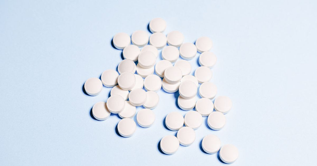Vitamin B6 tablets on a clean surface, recommended for morning sickness relief during pregnancy