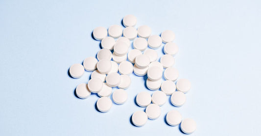 Vitamin B6 tablets on a clean surface, recommended for morning sickness relief during pregnancy