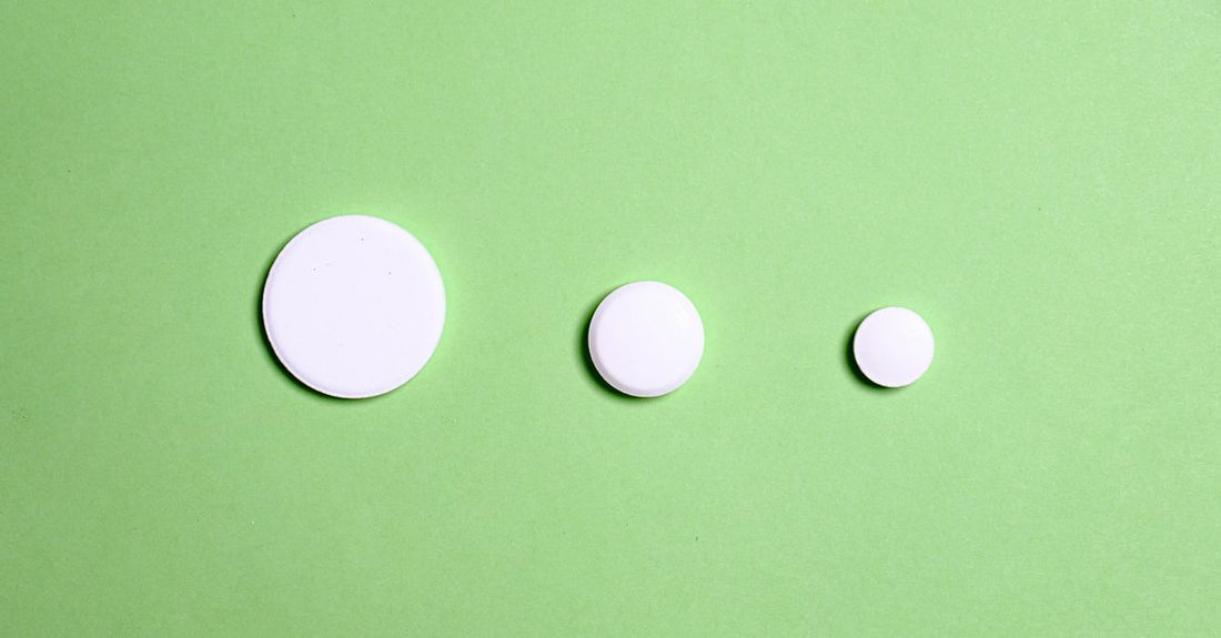 White calcium supplement tablets on a clean white surface, representing calcium supplements for women over 50 bone health.