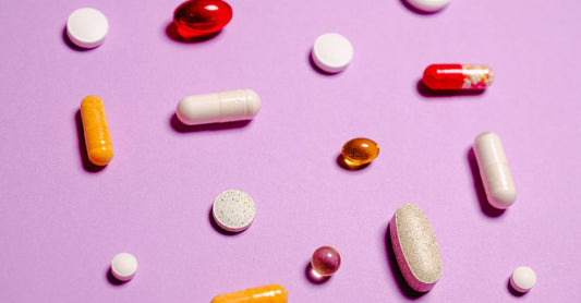 Multivitamin capsules in a glass jar on a clean surface, illustrating how to choose multivitamins UK.