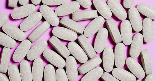 A selection of zinc supplement bottles and capsules on a clean white surface, illustrating how to choose zinc UK.