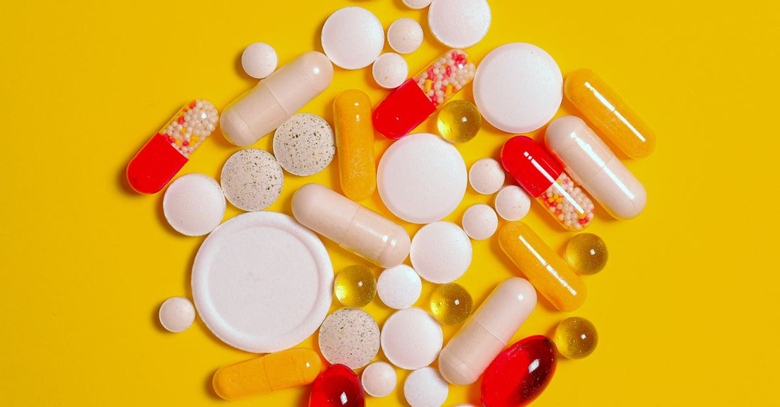 A row of multivitamin capsules and tablets on a clean white background, illustrating a multivitamins buying guide UK.