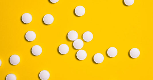 Vitamin B12 supplement bottle and pills on a clean white surface, illustrating how to choose B12 UK