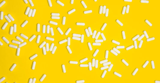 A collection of yellow-label vitamin B12 supplement bottles on a clean white surface, representing the best B12 2026 picks.