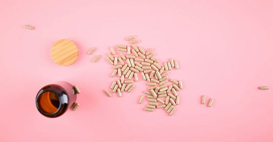 Probiotic capsules for IBS displayed on a clean white surface with a leaf motif, representing natural gut health support.