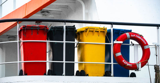 A 1 litre yellow sharps bin with biohazard symbol on a clean surface, representing safe needle disposal at home.