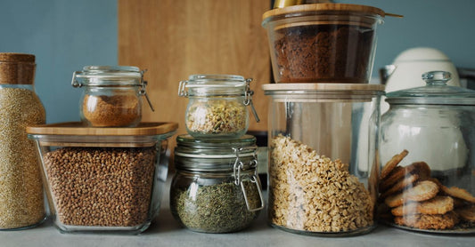 A glass jar of organic psyllium husk powder with a wooden scoop, representing the best psyllium UK 2026 for digestive health.
