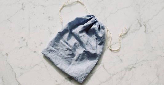 A flatlay of several drainable ostomy pouches with closure clamps on a clean white surface, illustrating best drain pouches UK 2026 options.