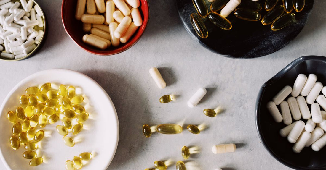 Flatlay of best diet & sports nutrition UK 2026 supplements including protein powder, shaker, and energy gels on a dark background
