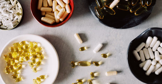Flatlay of best diet & sports nutrition UK 2026 supplements including protein powder, shaker, and energy gels on a dark background