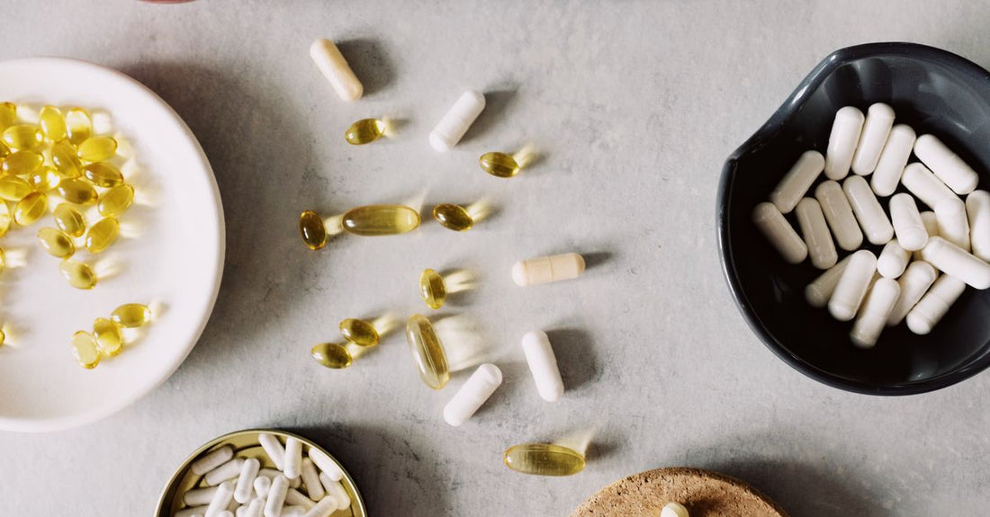 Glass jar of dietary fibre supplement powder with scoop on a clean surface, representing the best dietary fibers UK 2026 options for gut health.