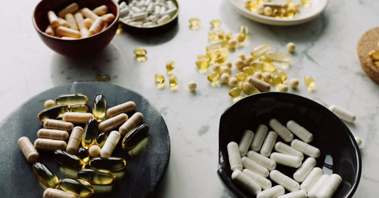 A flatlay arrangement of supplement bottles and capsules representing the best supplements UK 2026 available at Nutrisentra.